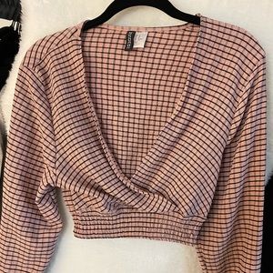 Cropped pink and black blouse with waist enhancing shape